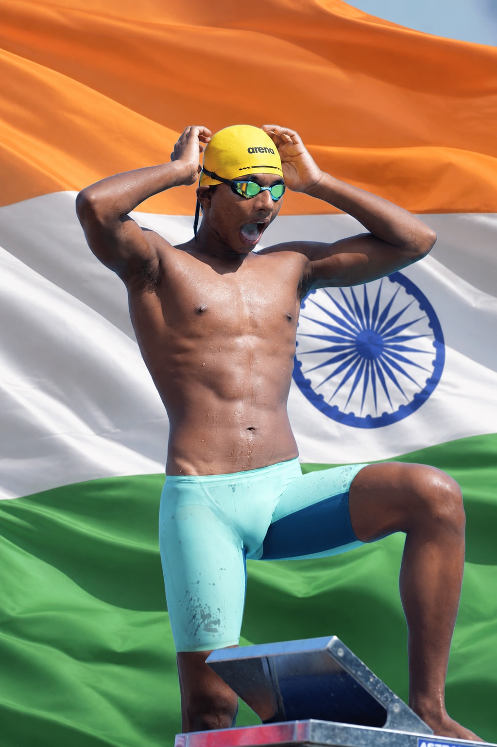 V. Kaveen Raj preparing to race against a flowing Indian tricolour backdrop